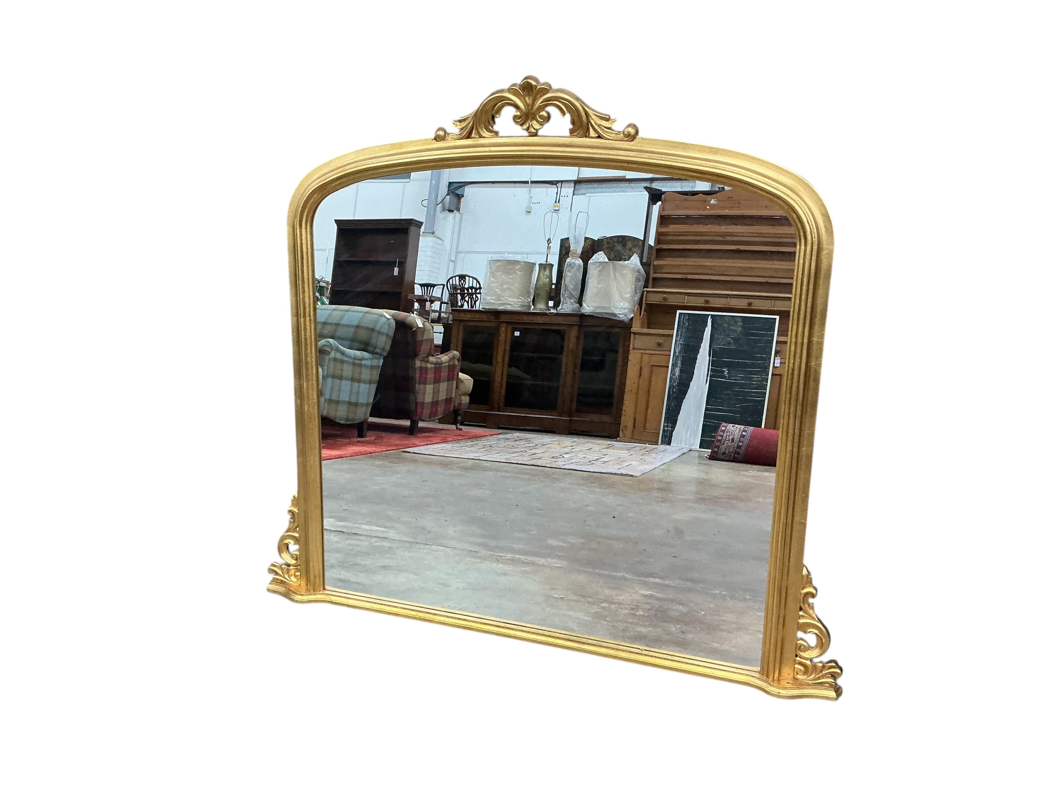 A Victorian style gilt composition overmantel mirror, width 184cm, height 110cm